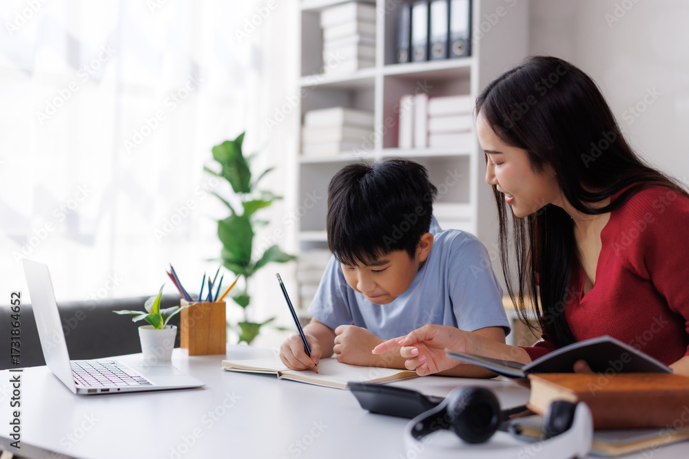 © Phimwilai - Asian mother helping son with homework at home