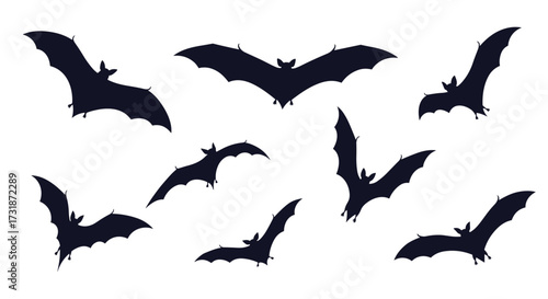 A collection of silhouetted bats in flight against a white background.