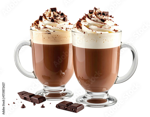 Two mugs of hot chocolate, topped with whipped cream and chocolate shavings, sit side-by-side.  Dark chocolate pieces are scattered around