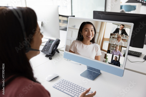 Woman conducting video call with multinational colleagues