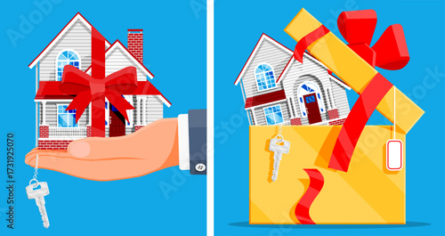 Hand holding house with red ribbon and key. Home purchase, gift residential property. Real estate deal concept.