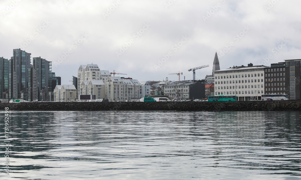 Obraz premium Reykjavik, Iceland. A calm harbor scene with a modern city skyline