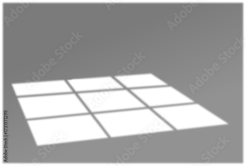 Warm sunset light casting grid shadows on a floor surface indoors