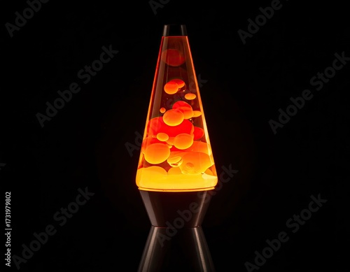 Orange lava lamp against black background