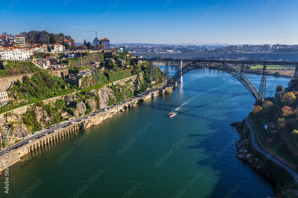 Obraz premium View from Infante D. Henrique Bridge on a Maria Pia Bridge old railway bridge in Porto, Portugal