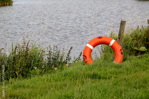 Red and White Life Preserver at a Rural Lakeside Location on a Summer Morning