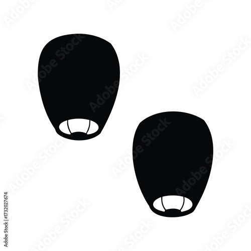 Silhouette of two floating sky lanterns against a plain white background