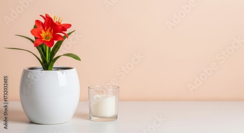 Wallpaper Mural Red flowers in a white pot a candle on a white surface against a beige wall Torontodigital.ca