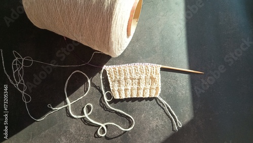 Knitting from white bobbin yarn, needlework, hobby. High quality photo