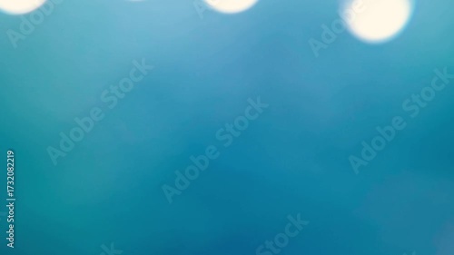 Raindrops falling from the roof on a blue background
