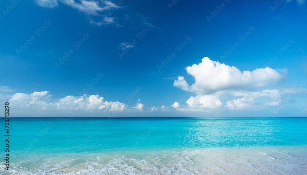 Fototapeta premium Bright Sunny Beach Scene With Blue Sky And White Clouds Over Calm Turquoise Water