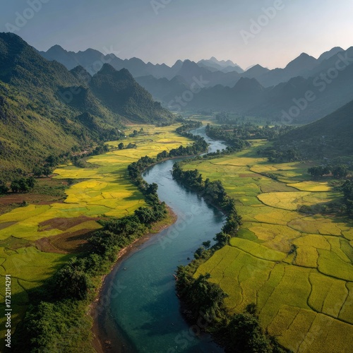 Scenic River Valley with Green Rice Fields and Distant Mountains Under Soft Light