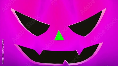 Closeup of a glowing jack o lantern with a sinister carved face in the dark