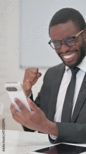 Businessman Reacting with Disbelief to His Phone