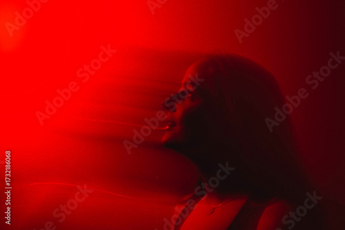 brunette portrait in Red color  with blurry long exposure technique 