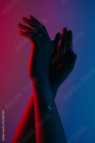 A person's hand reaching for something in the dark.