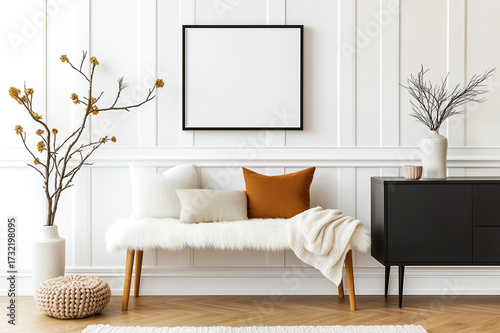 Pillows on bench near black cabinet. White classic paneling wall and blank frame on it. Scandinavian home interior design of modern living room.