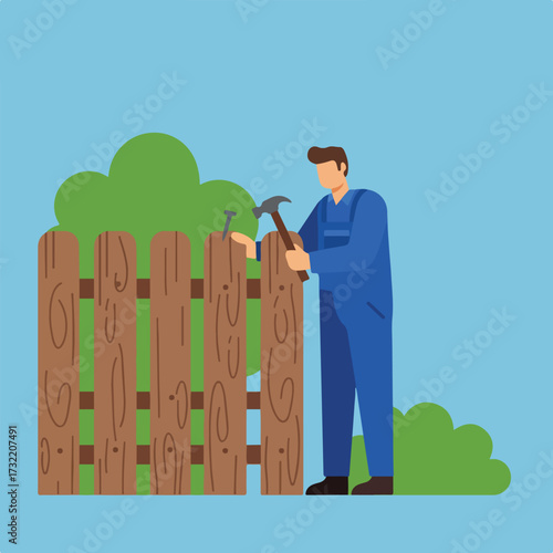 Man repairs wooden fence with hammer on light blue sky backdrop