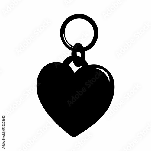 A black heart shaped pendant with metal ring on a white background