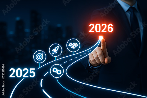 A businessman pointing to the year 2026 at the end of a glowing road with icons for target, rocket, handshake, and gears, representing a future business roadmap and strategy