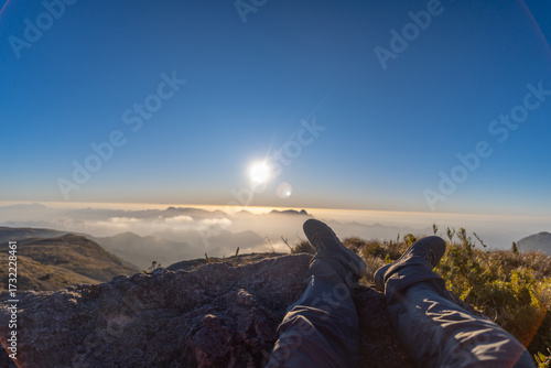 A hiker enjoys the sunset at Pedra do Açu along the Petrópolis–Teresópolis trail.