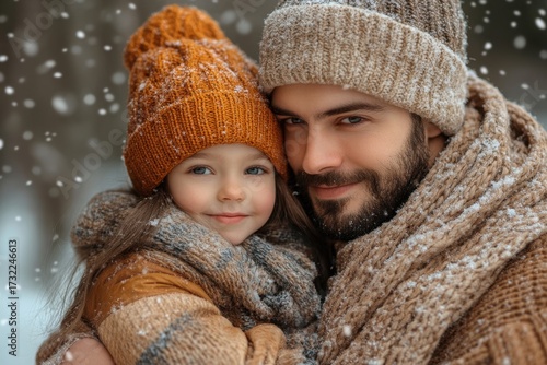 Man and girl in winter clothes walking in the snow.