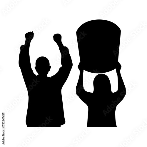 Silhouette of two people with raised arms and a sky lantern