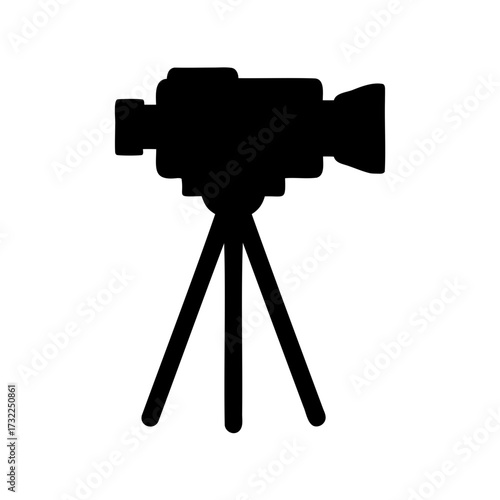 Classic movie camera on a tripod silhouetted in black and white image