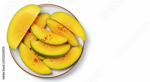 Overhead flat lay of raw mango slices with chili powder and salt for tropical pickle preparation, isolated on white background with copy space