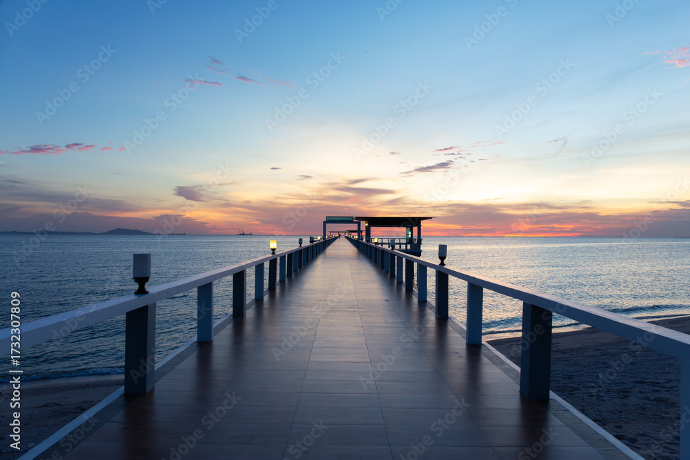 Fototapeta premium Seascape and building in Chonburi province, Thailand. Tile floor walkway at sunset. Represents tropical travel destination, relaxation, architecture with nature and scenic tourism background.