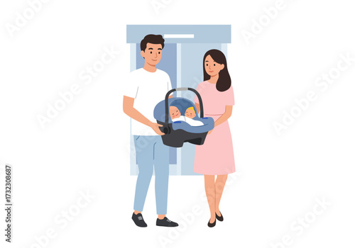 A couple holds a car seat with two babies inside standing in front of a blue background
