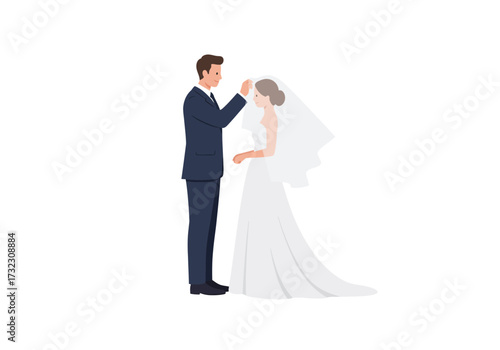 A groom adjusting a brides veil