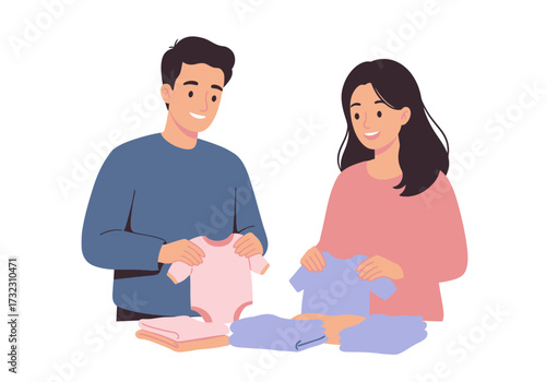 Couple folding baby clothes smiling