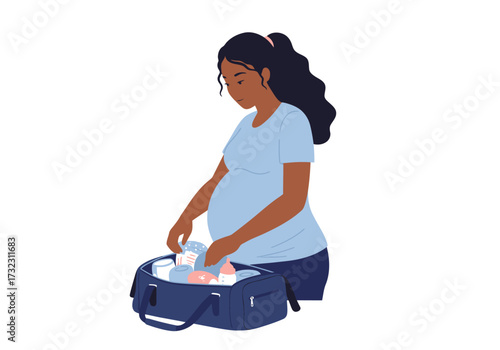 Pregnant woman packing a dark blue bag with baby bottles and supplies wearing a blue tshirt