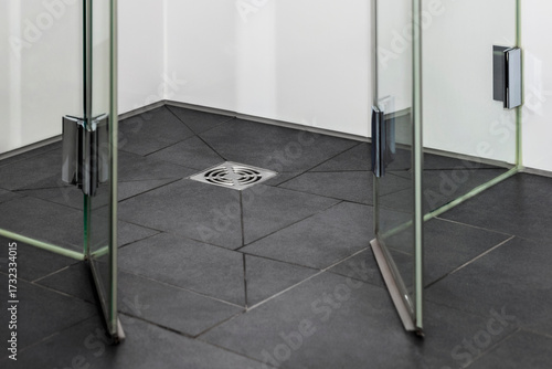 Drain in Bathroom. Shower Point Drain of Modern Drainage System in Modern Bath. 