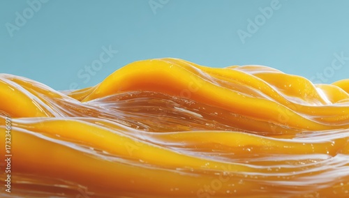 Abstract yellow, flowing, glossy waves against a light blue backdrop