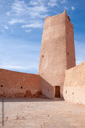 A historic tower in Ghardaia, Algeria, standing tall against a clear blue sky