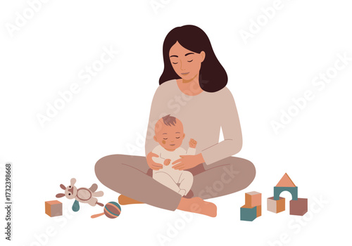 A seated woman holds a baby surrounded by toys and building blocks