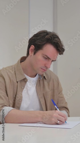 Vertical Video, Young Creative Man Writing a Business Letter