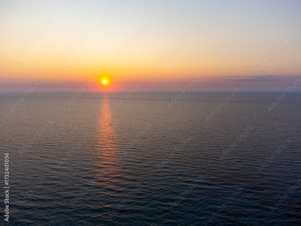 Obraz premium Aerial view of a beautiful sunset at sea