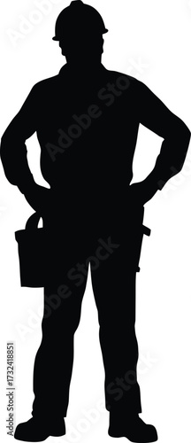 Full body silhouette of a construction worker with hands on hips silhouette