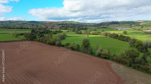 Aerial drone shot moving forwards over the Shropshire countryside in Clun, UK on a Summer day