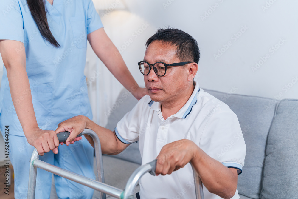 Obraz premium Senior man using walker while receiving support from caregiver in cozy interior, focusing on rehabilitation and elderly care, health and mobility assistance