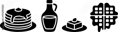 A collection of breakfast foods including pancakes, waffles, and syrup.