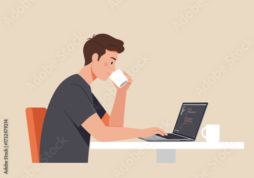 Focused man working on laptop while enjoying coffee at home office contemporary setting productive environment
