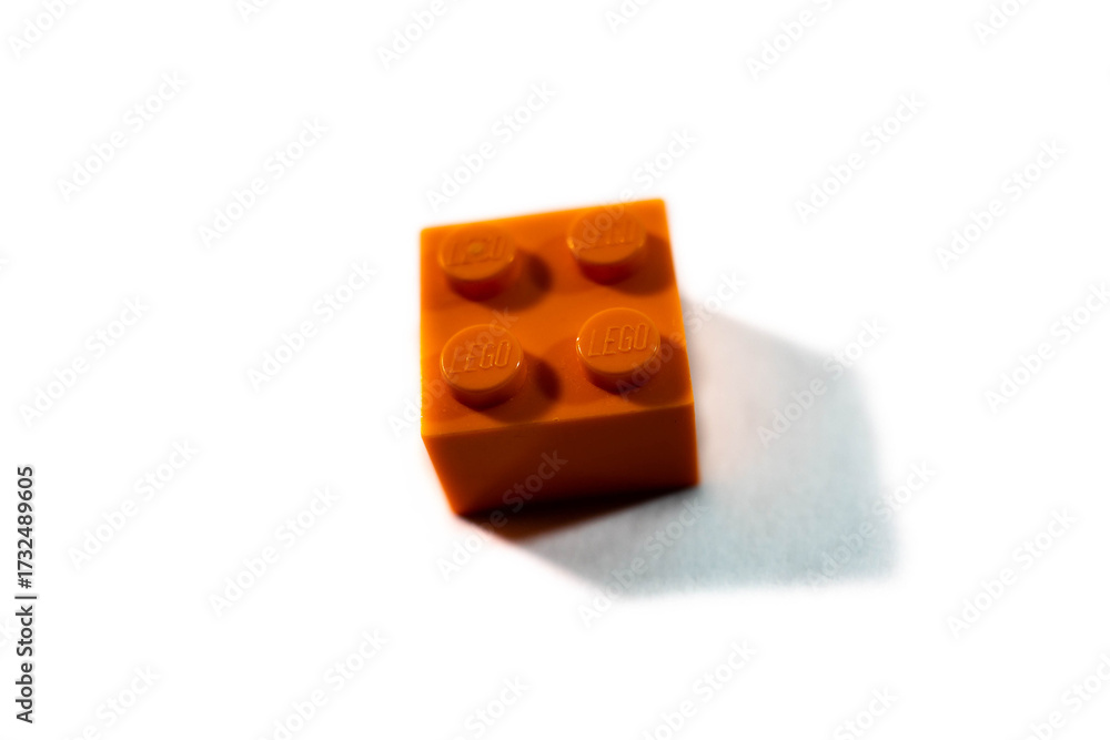 Obraz premium Miercurea Ciuc, Romania-29 September 2025: Single piece of orange Lego bulding brick on white background.
