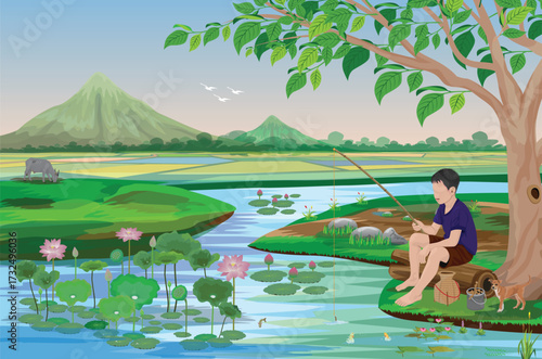 A country boy herding cattle sits under a tree, fishing on the bank of a canal.