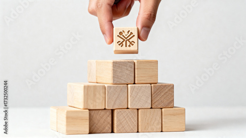 Hand Placing Symbol Block on Pyramid