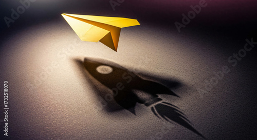 Golden Paper Airplane Casts Shadow of Rocket Ship Symbolizing Ambition Growth and Innovation