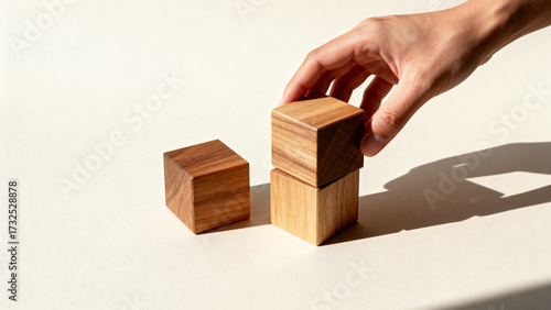 Hand placing wooden blocks